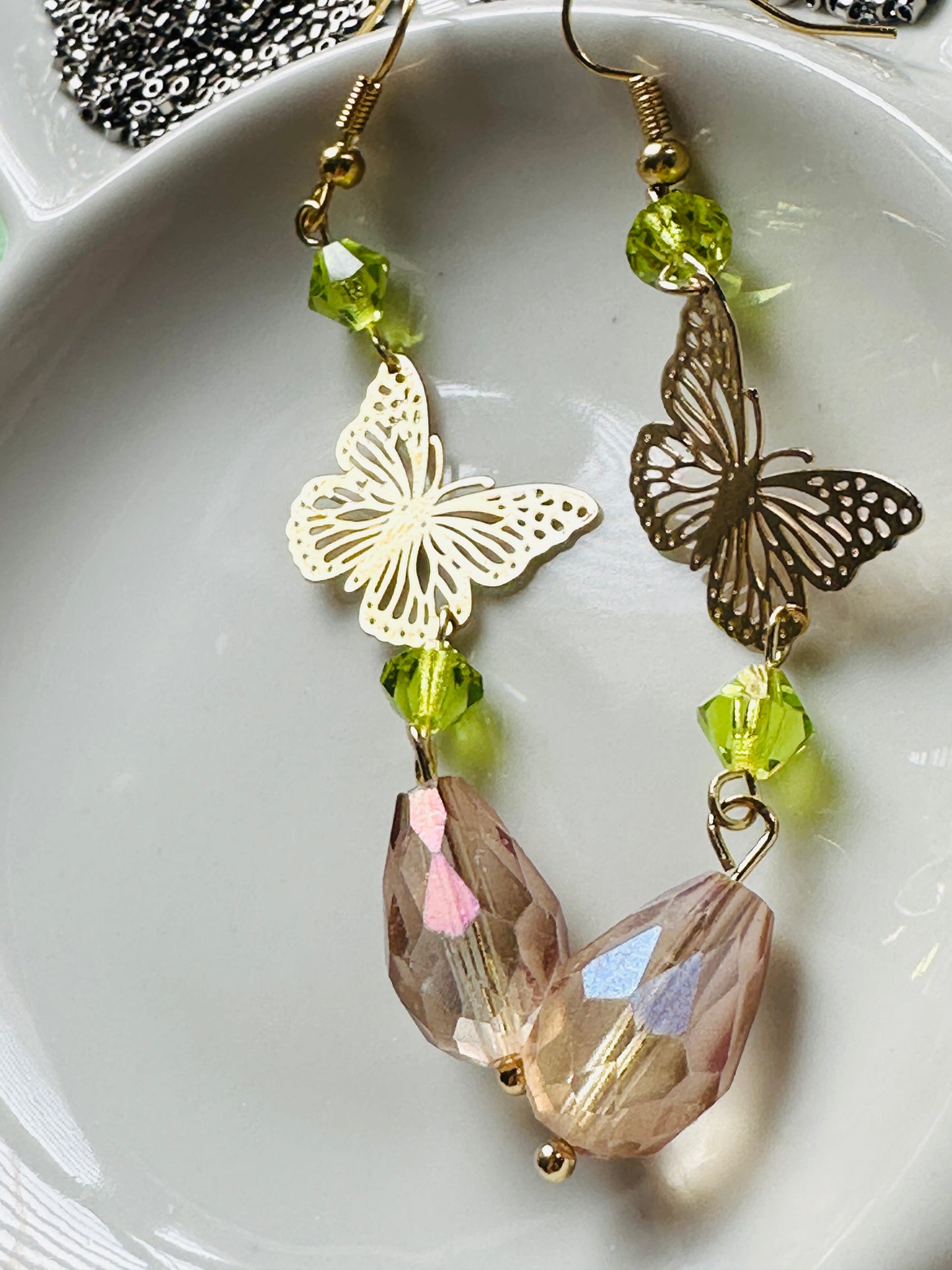 Handmade Butterfly chandelier dangle earrings with green and Antique lilac iridescent European glass crystal beads by Marianna Mills artist