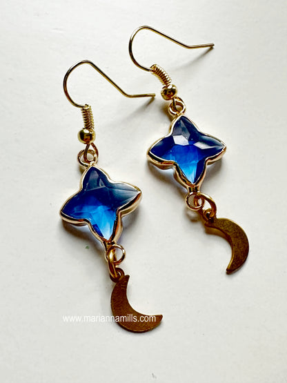 Celestial collection. One of a kind earrings, they can't be duplicated.  Designed and handmade by Marianna Mills.  Size: 2 inches  Blue glass star with metal outlining and natural brass moon shape drop.