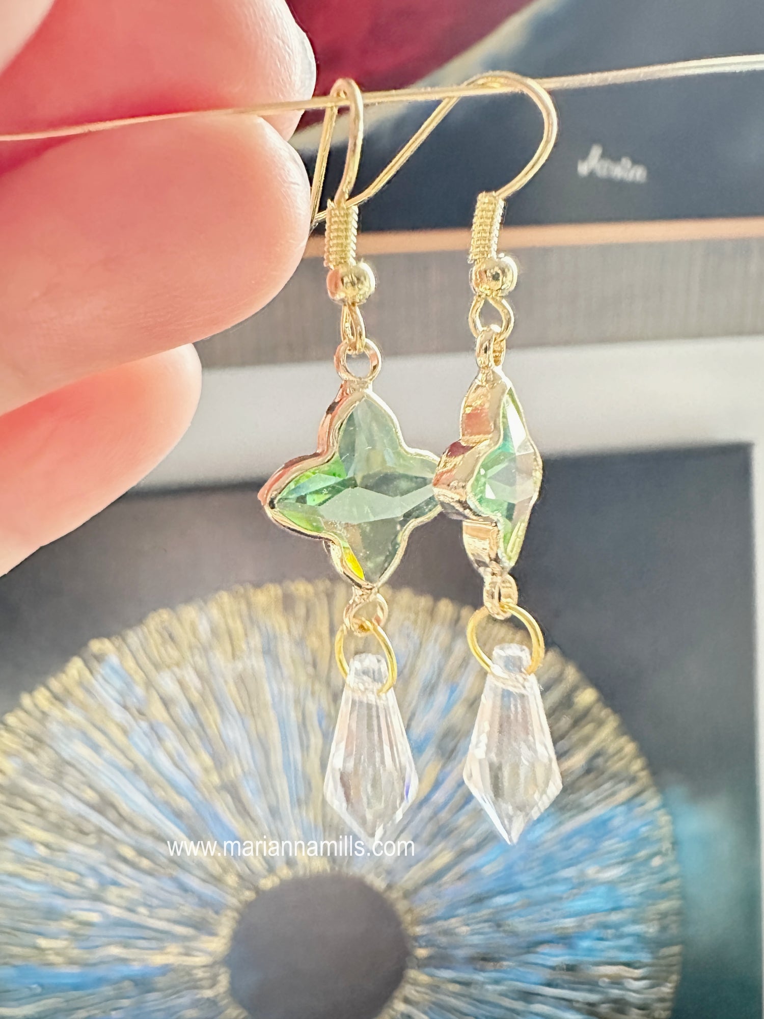 Celestial collection. One of a kind earrings, they can't be duplicated.  Designed and handmade by Marianna Mills.  Size: just a little over 2 inches  Light green glass star with metal outlining and clear crystal drop.