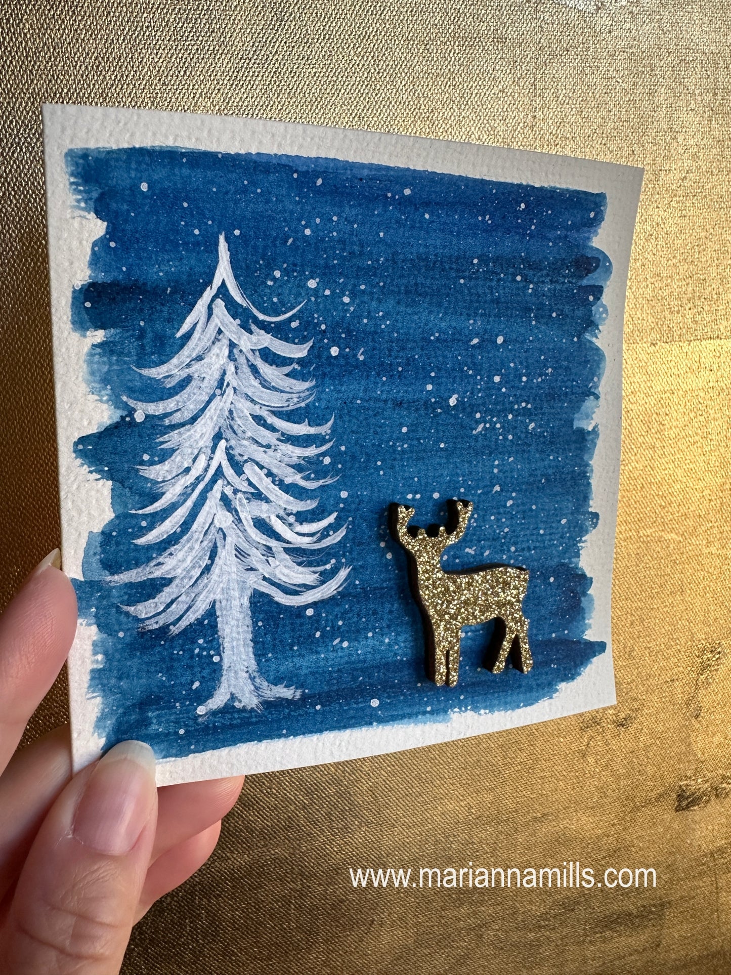 Hand painted Christmas Card #4 Snowy land with a white fir tree and glittery wood reindeer embellishment.