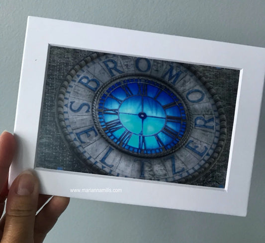 Matted art print by Marianna Mills of the Bromo Seltzer Tower blue clock in Baltimore, Maryland. detail photo of the blue clock face with no hands 2015